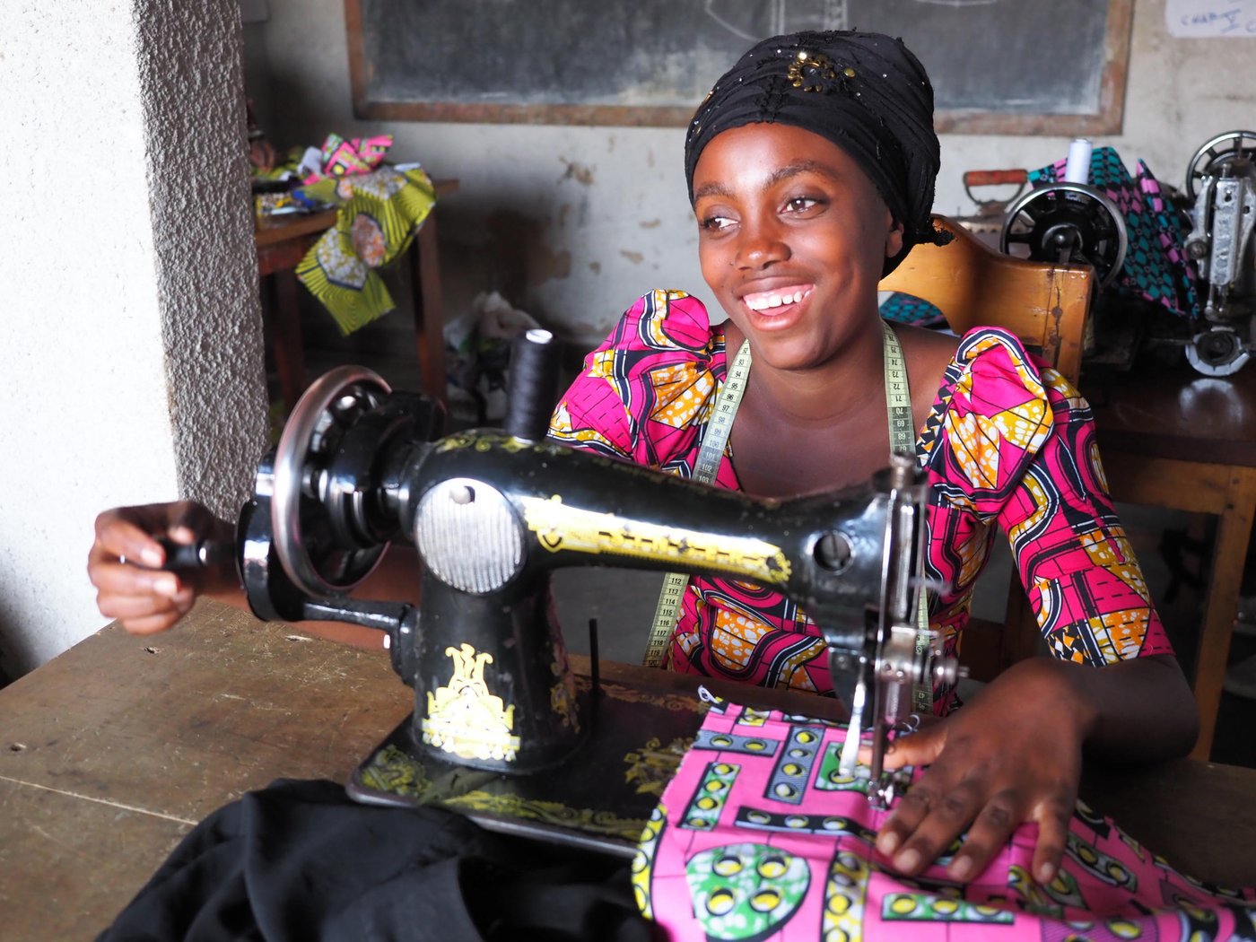 Rachel is twenty-years-old and lives with her parents, siblings and her 2-year-old daughter (name: Guylaine). She became pregnant when she was 17 with a boy from her village, but he disappeared when he revealed that she was expecting his child. Since August 2018, Rachel has been attending the NRC tailoring class in Kitchanga. These courses will last six months. After training, her dream is to start her own tailoring shop and to be able to give her daughter an education to in the future. She loves tailoring and she has made dresses for herself and her daughter. Before she was selected for the NRC tailoring class, she had nothing to do and now she is very happy to be able to attend the classes.
Rachel is from the village Ngingwe, Masisi territory, which is six kilometers from Kitchanga in the North Kivu province. She and her family had to flee during the night four years ago when the clashes broke out between armed groups. They travelled the whole night and reached Kitchanga in the morning. Rachel was very afraid when she had to flee and during this violence where she lost her grandmother and uncle. She misses them a lot. Rachel is still constantly afraid, and does not want to go back home until it’s safe. Since the attack, some people from the village have been back home to pick up food and their belongings, but they cannot sleep there, as the situation is still unsafe. Rachel has not been back home in Ngingwe since she and her family fled their home.
Rachel does not feel safe in Kitchanga either. She is scared that armed groups will enter Kitchanga and take over the town in the future. She does not feel well about being a displaced youth in Kitchanga. It is a big challenge for her because she is sometimes neglected. Since she also a single mother, people austersize her.
There’s also a lack of food in Kitchanga, and Rachel does not have enough money to pay school fees, therefore she dropped out of school after second grade in secondary school. Rachel also struggles to pay for health care and clothes for her daughter. After tailoring class, she usually helps her mother to do some household activities, for instance, fetching water and cooking dinner.
Photo: Ingrid Prestetun/NRC
