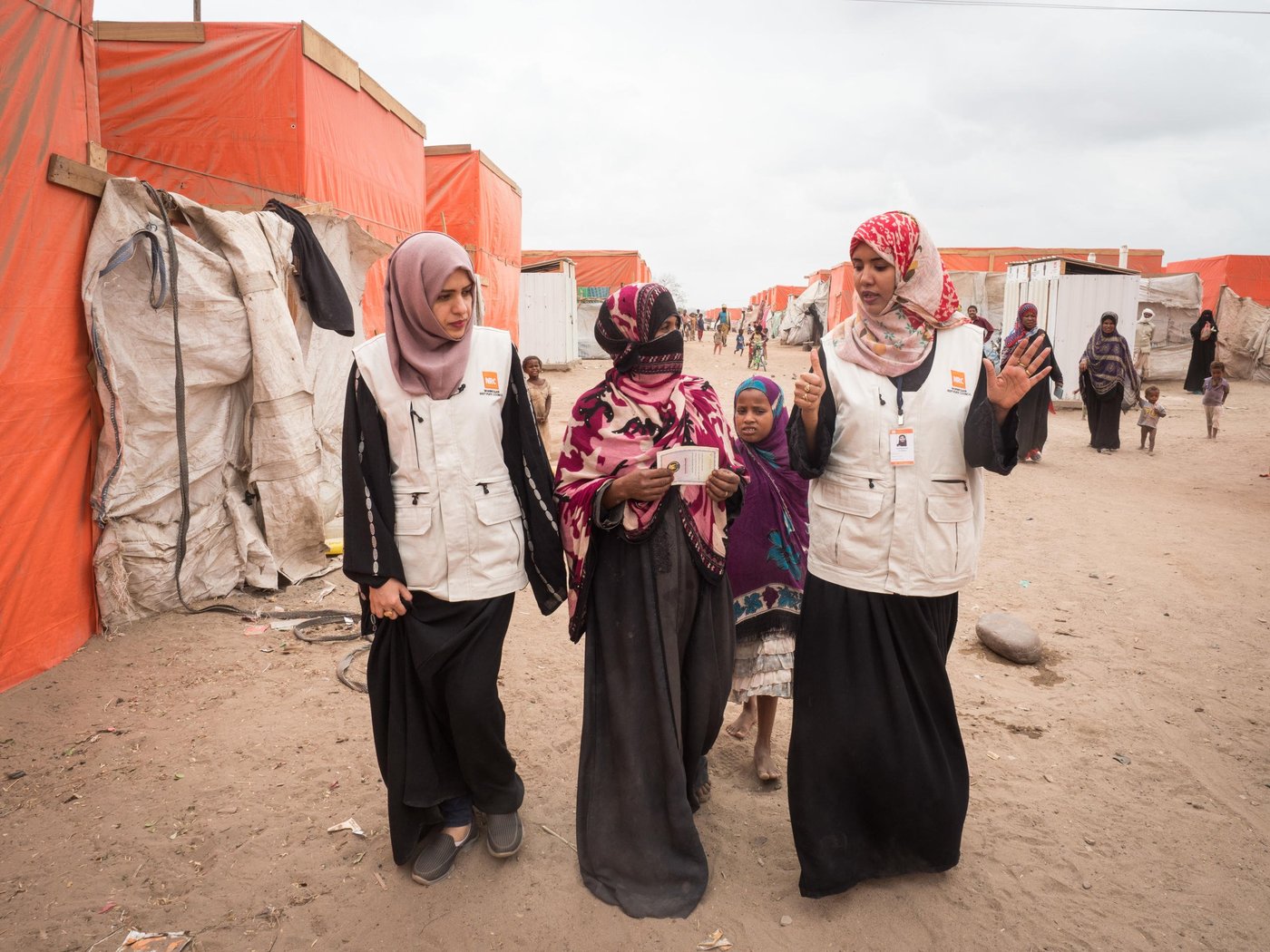 Ruaa Mohammed, Information Counselling Legal Assistance (ICLA) Assistant, and Nuhad Mubarak, ICLA Officer, are explaining child birth certificates to Nour, whose son Hamza received his that day.
Al-Mishqafa camp was established in late 2016 and initially hosted 60 displaced households (approximately 420 people). By 2018 the number of the households increased to 300 (2,100 people), at which time NRC, with funding from UNHCR, began providing cash assistance via its Information Counselling Legal Advice and Protection Programmes. The program further supported displaced families with IDs, supplying 88 people with ID cards, and 165 children with birth certificates.
In November 2018, NRC’s shelter department built 312 shelters and 120 latrines. The camp population is still in need of continuous support as they lack consistent access to food and safe water, and struggle daily with camp conditions that expose them to insects, snakes, scorpions and very windy, dry weather during the summer season.
Photo: NRC