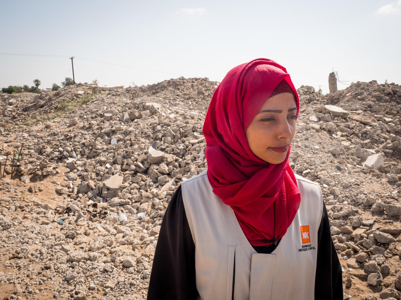 Aden, Yemen.
NRC’s education assistant Malka Mohammed (26) remembers March of 2015 well and how it went from being a joyful month of celebrations and weddings before it turned into a living nightmare. She worked as an English teacher in her home city of Aden when one day her colleague came running to her classroom, knocking madly on the door and shouting: "They’re attacking the city!"
"We evacuated the school, there was a lot of confusion. There was shooting everywhere," she recounts.
Over the next few weeks, it got worse and the fighting drew closer to Malka’s home.
"Every day I heard stories of how people had been killed and I saw the remains of destroyed buildings. It scared me to death. I was particularly afraid during those early morning hours around 5 am when the airstrikes began."
She remembers one day waking up to the screams of the little girl next door.
"I ran out on to the streets without wearing my abaya or even a scarf on my head. I was running like crazy and the street was full of people. It felt like it was going to be the last day on earth, the sky was covered in red lightening."
Malka and her mother ran as fast as they could. They eventually reached a house and were welcomed in by the people living there. They stayed until the next morning.
A stranger helped Malka that day. Now, she is helping others.
As an education assistant in southern Yemen, her job is to make sure children living in the midst of conflict can still access school. Through our education work, we rehabilitate and rebuild schools destroyed by shelling and other attacks, we distribute school materials, teach teachers and organise school feeding.
"We cannot lose education in Yemen. If we lose education, we can lose a whole generation," she says, and continues: "Education is so important, and that’s why we try to support young Yemenis to create a better life for themselves, and a future." Photo: Ingrid Prestetun/NRC