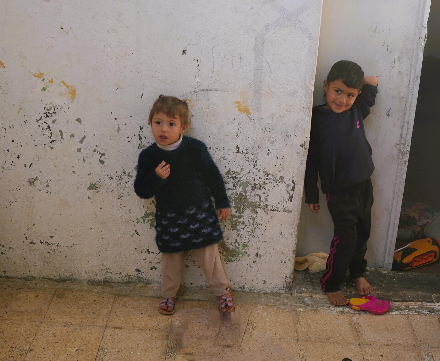 Aya and Hasan standing outside of their home to say goodbye. Photo: Shaden Abdulrahman/NRC