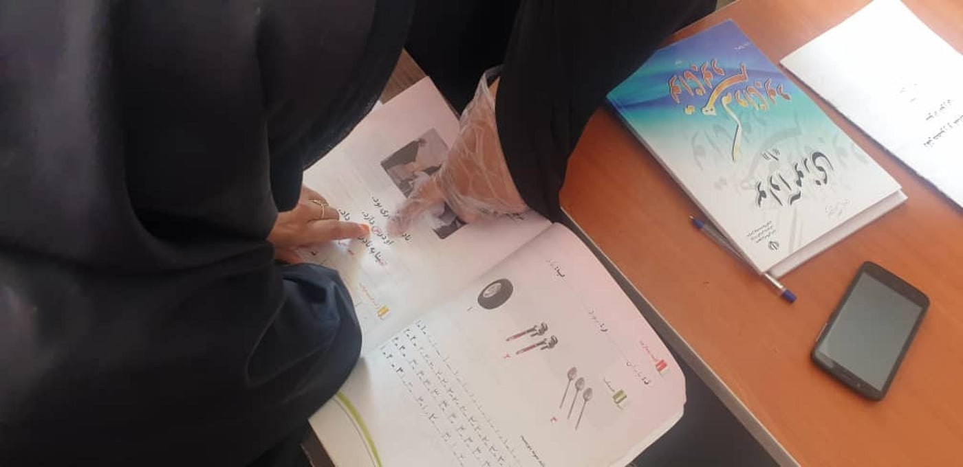 A teacher showing the alphabet to her Afghan student in a literacy and numeracy class in Iran, which is funded by the European Union Humanitarian Aid.
Photo: Melika Kermani/NRC