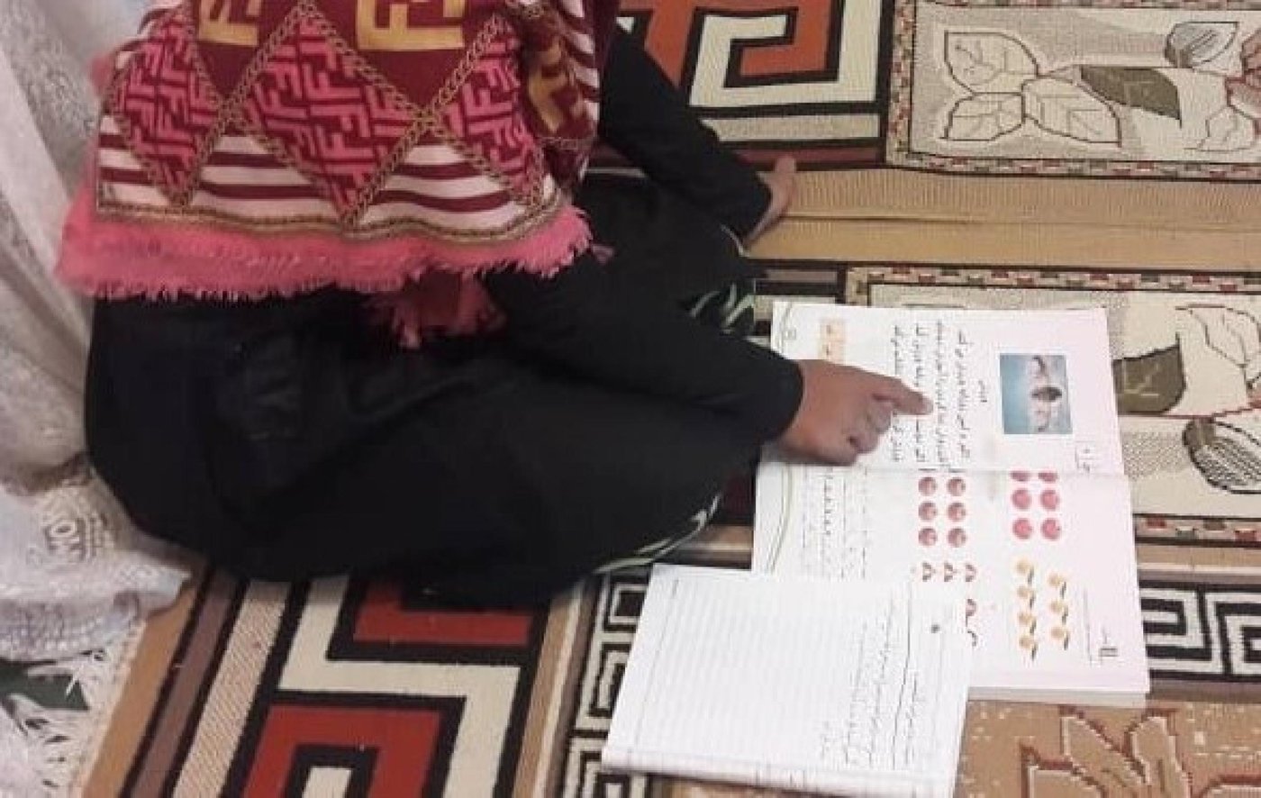 An Afghan girl reviewing her basic literacy and numeracy lessons in Iran, funded by the European Union Humanitarian Aid. Photo: NRC