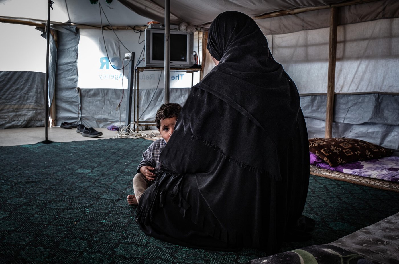 Hana, mother of seven children, fled Hawija in 2017 as the Iraqi government retook the city, one of the last remaining IS strongholds, to a displacement camp in Kirkuk governorate. Intelligence officials confiscated her civil documentation after she arrived in the camp. "My husband joined IS while the group was in control, but he died in an airstrike with my eldest son in 2017," she says. Now she and her children are alone and unable to leave the camp, barred from attending school and denied access to healthcare and social welfare.
"My husband took the wrong path. He took my oldest son and left us to fight with Islamic State. They are both dead now, and I am alone in this camp with my young children. Three of them don't even have identity documents (ID). My husband destroyed our lives, me and my children suffer," the widow says.
Her three children born under IS rule do not possess birth certificates and, as a result, cannot obtain IDs. She says during the winter, her children got sick from the cold but was unable to take them to a hospital outside the camp.
She tried to seek assistance from a lawyer working with a humanitarian organization to start the procedure to formally divorce her husband and try get her ID back and obtain documents for her children, but they said they were unable to assist because of accusations of IS affiliation. She says the humanitarian assistance she receives is limited because priority is given to those can provide identification.
* Name was changed for protection concerns.
Photo : Tom Peyre-Costa/NRC