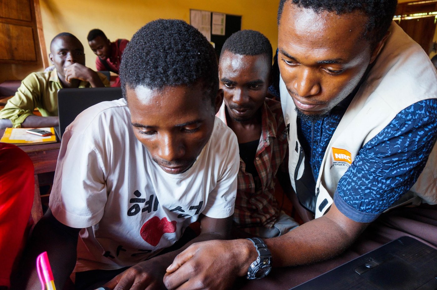 Deo – ICT teacher, 27
with Festo Philips Emmanuel, 23, host community youth attending ICT classes in Mtendeli refugee camp.
Photo: Guri Romtveit/NRC