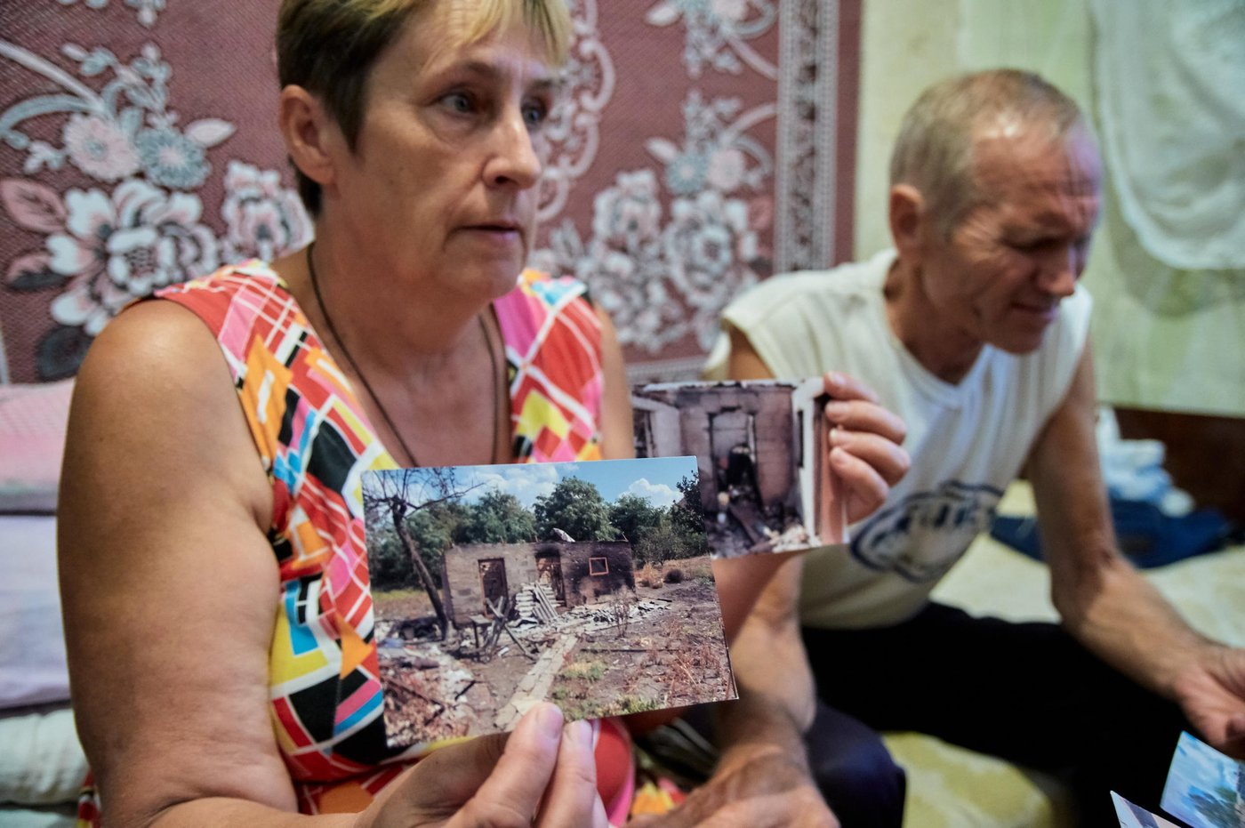 Nadiia Parfemchuk, 54, and Heorhii Mironenko, 61 live in Kurakhove collective centre more than five years without bleak prospects to return home in Marinka, as it is destroyed and located in mine-contaminated area with everyday shelling.
“We lived in a big fully refurbished house in Marinka and had everything what we needed for normal life. We have been living here since August 2014, it was impossible to stay home, as it became epicentre for hostilities. When our house was hit, we were in Kurakhove with my husband’s sister. Everything was burnt. Nothing remained there, we were trying to get our staff, but could not do it, because of active hostilities. We came here in what we were wearing. Local town residents and humanitarian organisations helped us a lot. My daughters live here in Kurakhove one in collective centre, another one rents an apartment”, says Nadiia.
Nadiia was working in the kindergarten, however, she got under reduction and lost her job. She did not reach retirement age and barely makes the ends meet. Their house is destroyed, and they have to pay 2,000 hryvnias (nearly 70 US dollars) for utilities in cold season. It is very mouldy here.
Heorhii started working recently, as they need to survive somehow. Most of humanitarian assistance is provided to pensioners over 65 years. Their house is in the red zone, they cannot even access it. Even military people do not walk there. Nadiia and Heorhii say that they would like to get house somewhere in the safe place.
Photo: Dmytro Telushkin/the Norwegian Refugee Council