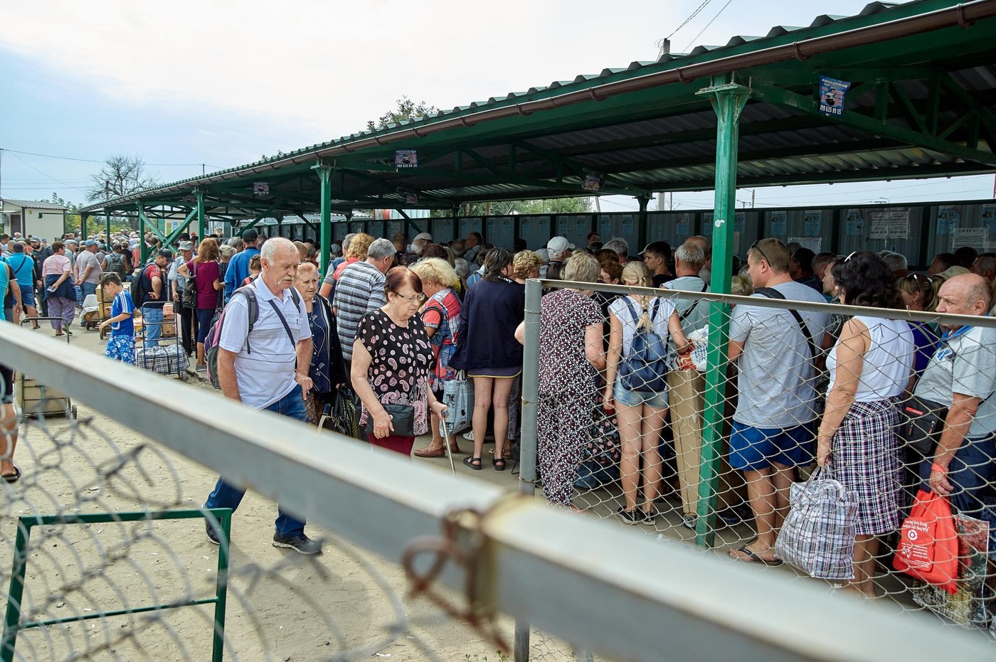 Civilians have to cross the contact line through five entry-exit checkpoints serving entire the Donetsk and Luhansk regions. They cross to visit their families, go shopping at the market, obtain documents or access essential state service as well as to watch on their property on both sides. Most of those people are over 60 who travel to access their pension, which is the only source of income. People are queueing at the checkpoint for hours, either harsh winter conditions or scorching sun in summer. While there have been improvements in the crossing conditions over 90 people died due to health complications at the checkpoints during 2018-2019. Despite the considerable efforts made by the government and humanitarian community, checkpoints still lack basic services such as hygiene facilities, drinking water and first aid.
Photo: Dmytro Tielushkin/The Norwegian Refugee Council (NRC)