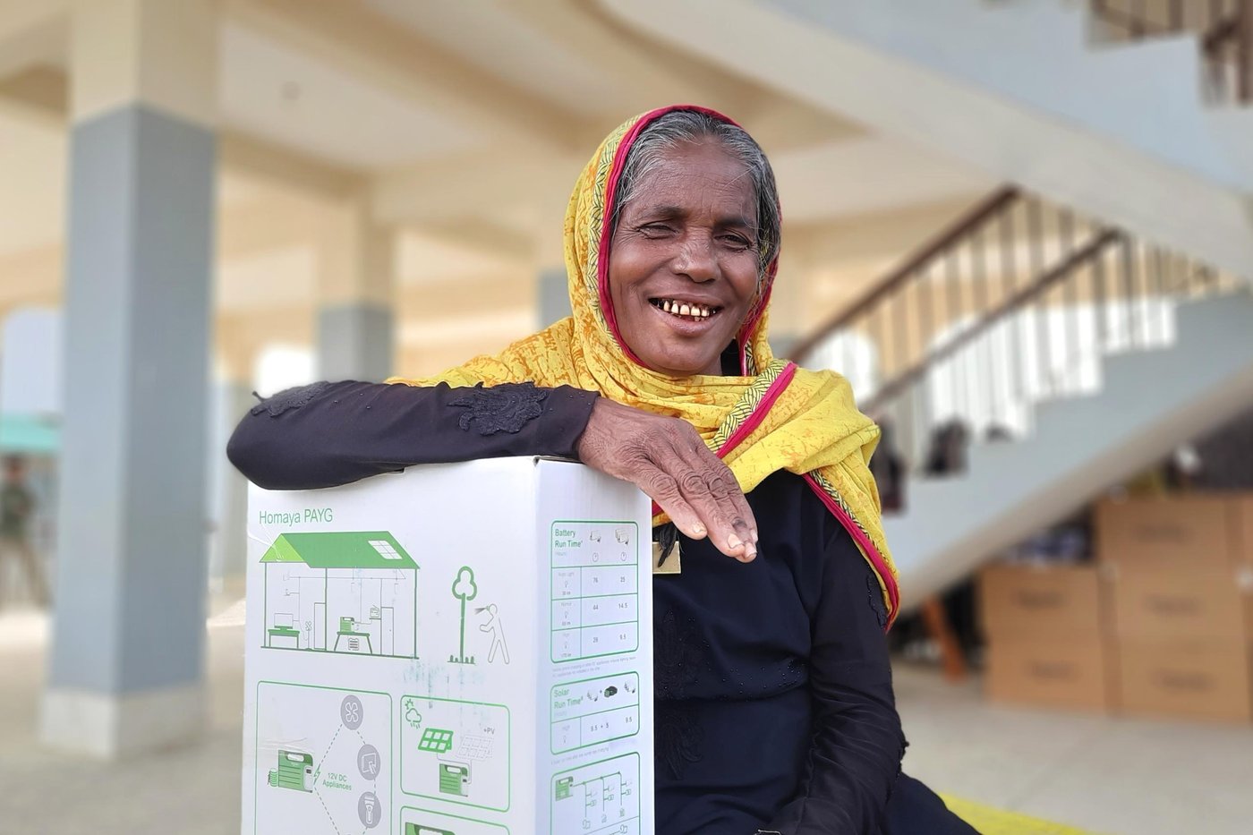 Isamon bibi poses with her “magic box” from NRC. Photo: Ayesha Nawshin/ NRC