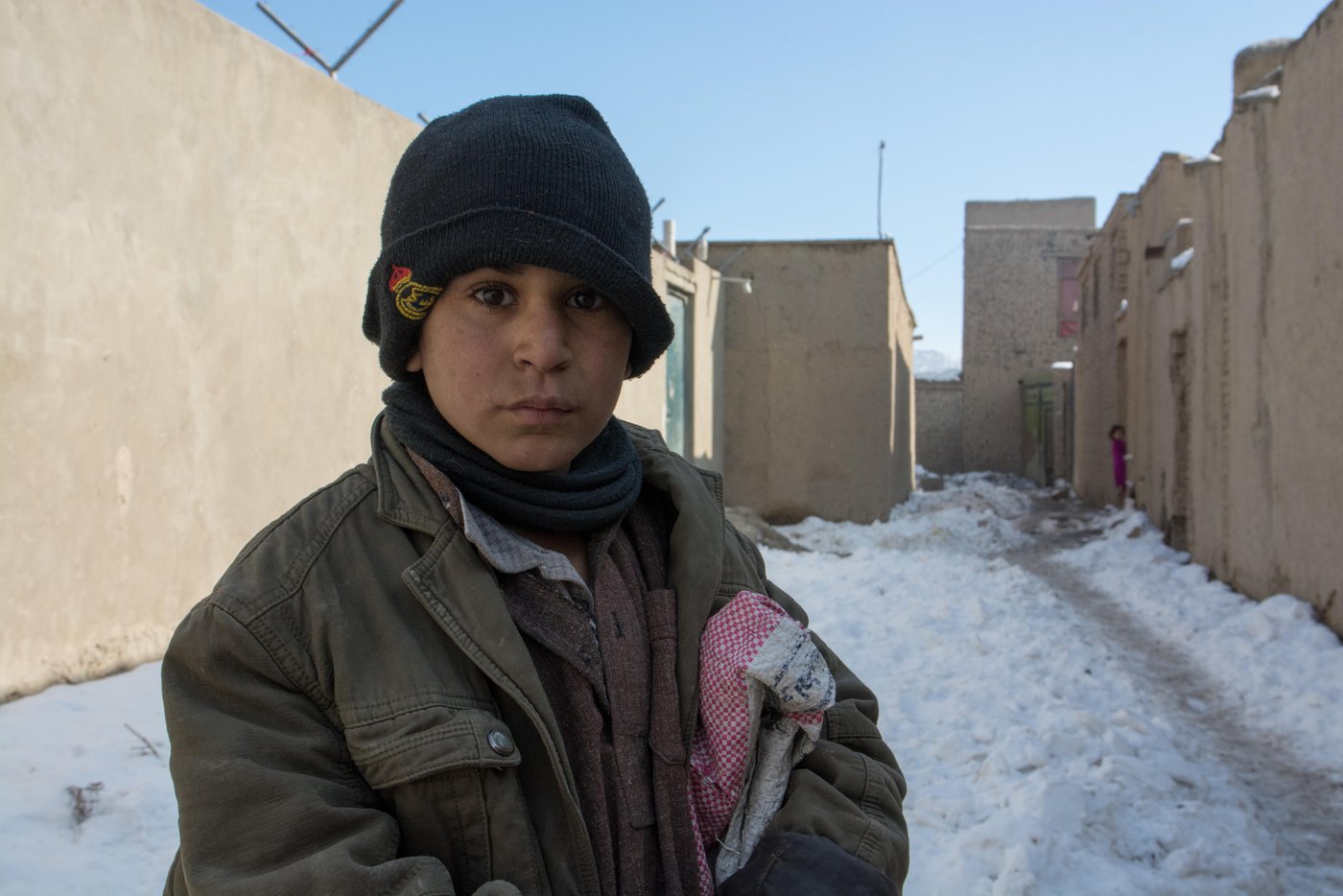 What is your name?
Akhtar Mohammad.
How old are you?
I don’t know
Are you going to school?
No.
Then what are you doing during the day?
I’m collecting scarps on the streets.
Akhtar a thirteen-years-old who deals with paper, notebooks and books all the day do not attend the class. Akhtar is an IDP child living in an IDP settlement in west Kabul. He and has family has fled conflict some two and half years ago from Kunduz province. Akhtar has five siblings. He and his father works on the streets collecting scraps. He usually collects Pepsi cans and papers. He sells the cans and brings the paper home to burn to make the house warm and also, to cook food.
As the Afghan children are very delightful for the first winter snowfall on Friday and are playing and making snowballs; Akhtar has left the home with a bag to collect scraps. Akhtar and has family spent last winter in makeshift tents. NRC with generous support of DANIDA upgraded their shelter to fight against the freezing temperature this winter. Photo: NRC/Enayatullah AzaD