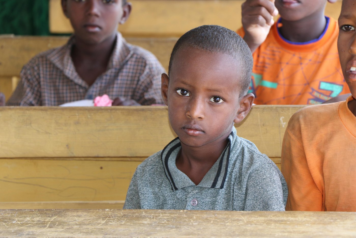 Norwegian Refugee Council constructed a primary school in Barsanguni village in Kismayo town, lower Jubba region. The school comprises of four temporary classrooms, an office, four gender-segregated latrines and child friendly space.
Both local community and Jubbaland state’s Ministry of Education actively engaged in the site identification, mobilization, enrolment of students, and construction of the primary school for the vulnerable host-communities.
A total of 587 students (320 boys, 267 girls) were enrolled and are currently attending morning and afternoon classes. The school uses the recently launched Somali curriculum and operates up to grade-3. The school has 5 teachers who are provided with teacher incentives by NRC.
Nine community education committees (CEC members) 3 of them females have been given capacity building training on school management, leadership and CEC roles. The CEC members are currently taking part in the day to day management of the primary school.
Children in Barsanguni didn’t have opportunity to attend to school due to lack of school in the area. Before the collapse of the Siyad Barre regime in 1990, the village only had a 2 classroom school those were later destroyed by the warring sides during the civil war. The village had no school since then, leaving hundreds of children without education.
Somalia has one of the lowest primary school enrolment rates in the world. More than three million children in Somalia are out of school. Those in South and Central Somalia are affected the worst. Parents are not able to fund their children’s education. In addition to poverty, long distances to school, and safety concerns.
The Integrated protection solutions for women and children affected by displacement is a project that seeks to substantially reduce challenges that are impeding the protection and recovery potentials of women and children affected by displacement
To achieve this overarching goal, specialized protection services are combined with tangible assistance packages to assist displacement affected communities develop resilient capacities necessary to address protection issues affecting women and children.
Specific priorities include ensuring displacement affected children and youth learn in protective and child-friendly environment, strengthening and expanding prevention and response to Sexually Gender Based Violence (SGBV) and access to protection services for IDPs, and consolidating recovery potentials for displaced women and youth. A total of 20,204 individuals are targeted across four hotspot districts in Jubaland (Kismayo) and Somaliland (Buroa, Hargeia, and Erigavo). This project is generously funded by King Salman Humanitarian Aid & Relief Centre (KSrelief).
Photo: Abdulkadir/NRC.