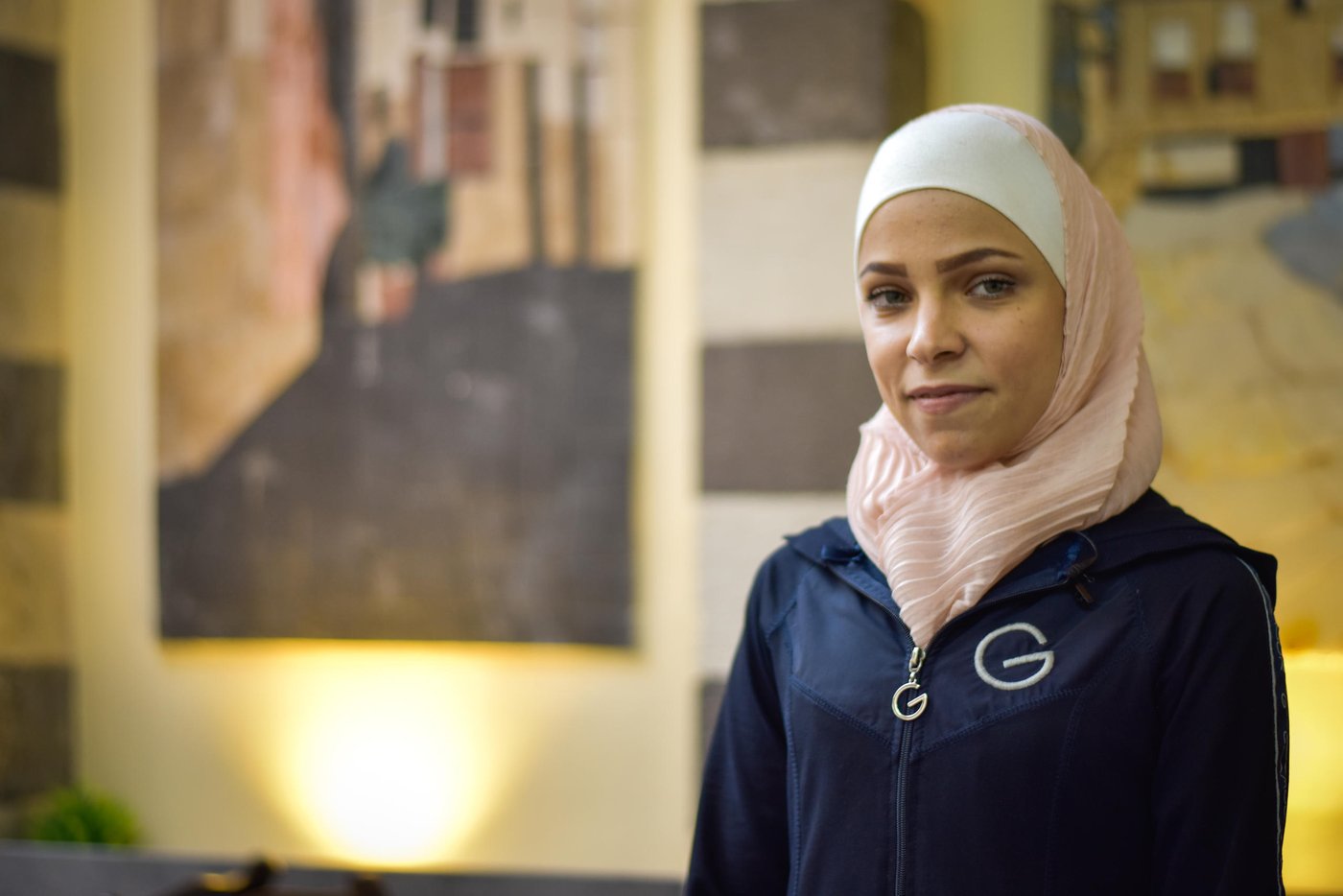 A woman looking into the camera with a determined look.