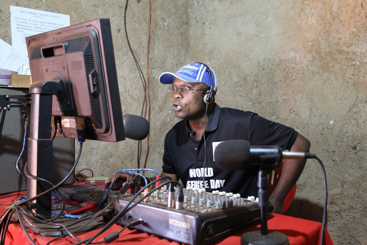 Gabriel is a presenter at Umoja Radio 92.3 FM
He was once a refugee in Mtabira where they established a radio station. But after a very short time, the refugee camp was closed and they were taken back to Burundi. After the recent conflict in Burundi he fled again and arrived in Nyarugusu two years ago. He got another opportunity to work in a community radio station at Radio Umoja. His job entails reading the news, sports, entertainment. 

Quotes from Gabriel:

"Yes, truly I am very satisfied to be here at this moment, since this has been a dream for me since my childhood I have always wanted to become a journalist. Therefore, I have benefited from this opportunity to be a journist in this radio station called Radio Umoja. Here we have various programmes that we broadcast."

"We have news bulletins, we also have music programmes, as well as sports. Our main objective is to inform the public about what is happening elsewhere across the world. We have various information sites, for example through the internet. We also listen to various radio channels, the biggest being World Radio. We are also following various media outlets."

"We have various programmes that we transmit. For example we have drama, we have music, and we also have sports to entertain our listeners. Our listeners appreciate our work very much, through what we are doing in terms of transmission of programmes. We also have information that we provide as well. 
Being a refugee is very difficult. It is never easy. Therefore, we try to support since being refugees is a forced event. Therefore, we try to do all that we can so as to support. And we hope that one day, peace will return to our country and we shall make the decision to return to our country of origin."

Photo: NRC Ingrid Prestetun