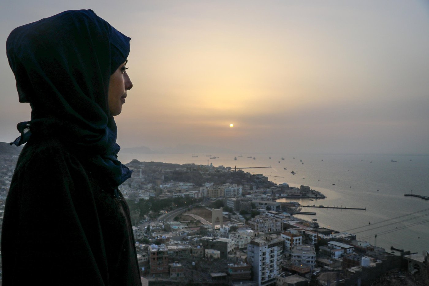 Aden, Yemen.
NRC’s education assistant Malka Mohammed (26) remembers March of 2015 well and how it went from being a joyful month of celebrations and weddings before it turned into a living nightmare. She worked as an English teacher in her home city of Aden when one day her colleague came running to her classroom, knocking madly on the door and shouting: "They’re attacking the city!"
"We evacuated the school, there was a lot of confusion. There was shooting everywhere," she recounts.
Over the next few weeks, it got worse and the fighting drew closer to Malka’s home.
"Every day I heard stories of how people had been killed and I saw the remains of destroyed buildings. It scared me to death. I was particularly afraid during those early morning hours around 5 am when the airstrikes began."
She remembers one day waking up to the screams of the little girl next door.
"I ran out on to the streets without wearing my abaya or even a scarf on my head. I was running like crazy and the street was full of people. It felt like it was going to be the last day on earth, the sky was covered in red lightening."
Malka and her mother ran as fast as they could. They eventually reached a house and were welcomed in by the people living there. They stayed until the next morning.
A stranger helped Malka that day. Now, she is helping others.
As an education assistant in southern Yemen, her job is to make sure children living in the midst of conflict can still access school. Through our education work, we rehabilitate and rebuild schools destroyed by shelling and other attacks, we distribute school materials, teach teachers and organise school feeding.
"We cannot lose education in Yemen. If we lose education, we can lose a whole generation," she says, and continues: "Education is so important, and that’s why we try to support young Yemenis to create a better life for themselves, and a future." Photo: Ghida Abdulatef /NRC