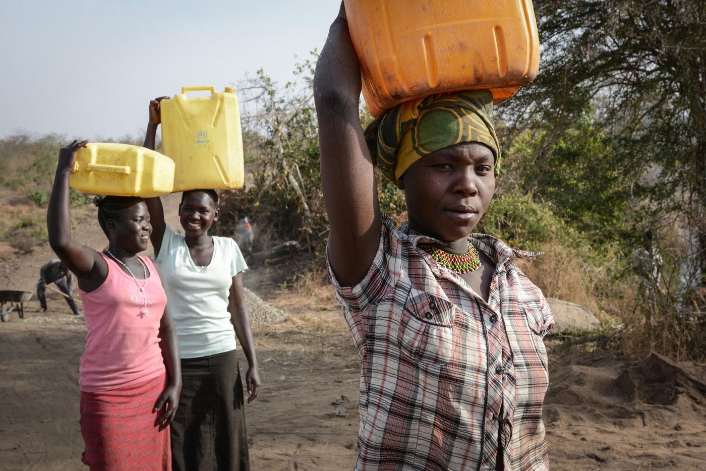 Never Rukia (28) from Uganda in front and Mary Kiden (17) and Christin Awate (16) from South Sudan are collecting water from a new water point in Bidibidi, Uganda which is being used by both refugees and the host community.
"Wars are no good for the civilians. I am glad Uganda can give them land and provide security," says Never.
She welcomes the refugees to her neighborhood.
"It has some benefits for us as well. There are for example more goods being sold at the market now. And there are clean water sources available to us, as well as the refugees. I think we should stay together in harmony and share the available resources," she explains.
NRC is seeking funding to continue lifesaving programmes for refugees here.
Photo: NRC/Tiril Skarstein