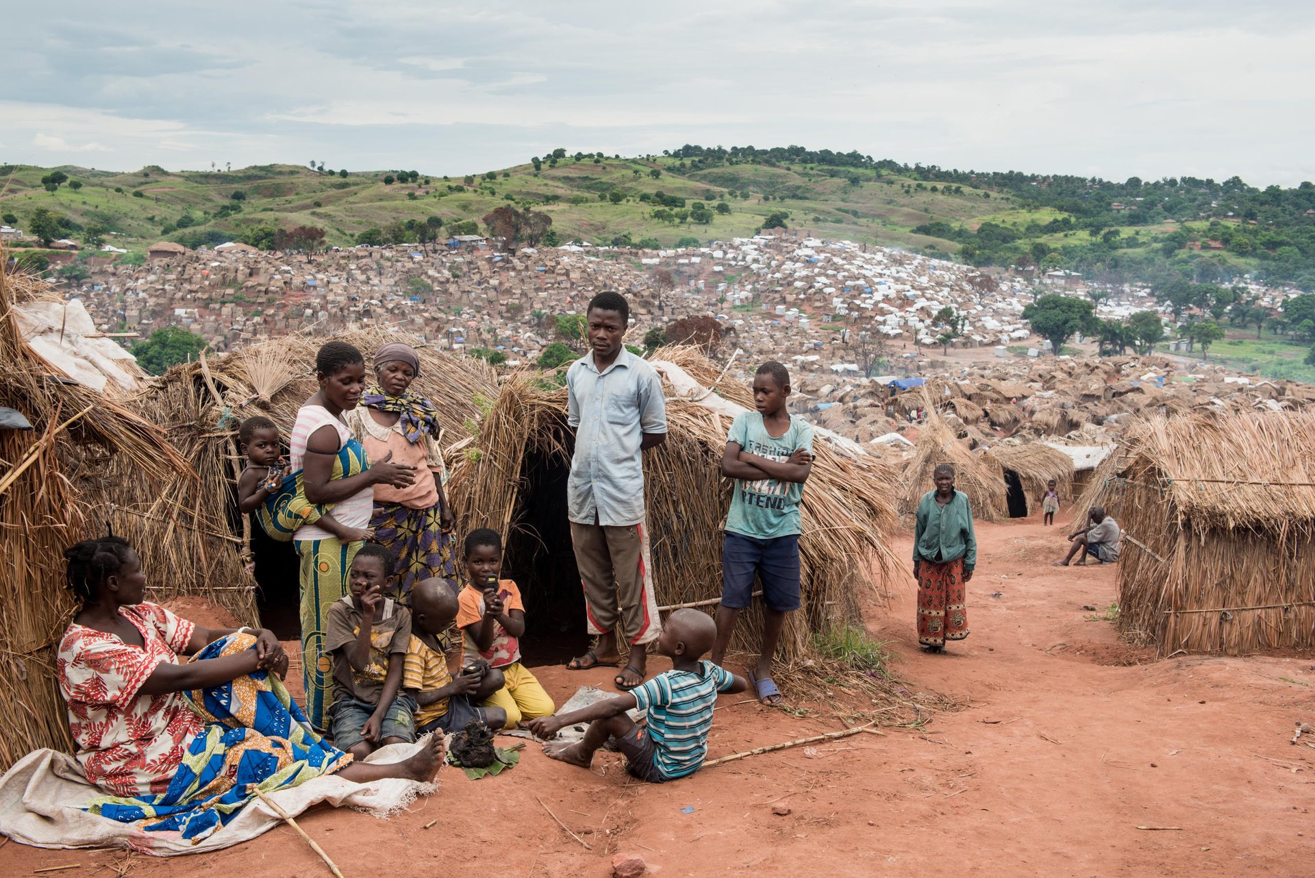 The Katanika Displacement Settlement is located just outside the centre of Kalemie town.  The settlement houses nearly 9,500 families (just under 70,000 individuals) most of whom fled violent interethnic clashes in Kalemie Territory.  The majority of people living in Katanika arrived in two waves—the first wave in January 2017 and the second in May.  Very little assistance has been given to people living in Katanika due to administrative blockades and lack of funding for local and international NGOs to adequately address needs.  

Food is scarce in the settlement and the only means to earn money is through menial jobs like chopping wood, transporting bags of sand and working in the fields.  The average amount a displaced person earns for this kind of work is 625 Congolese francs or less than US 0.40 cents a day.

Health needs are rife in the settlement. Many are suffering from malaria, malnutrition, severe diarrhea, dysentery and cholera.  There have also been reports of hypertension and strokes.  There is no aid for pregnant women or women who give birth.  People who get severely ill and need professional medical attention rarely have the means to go to hospitals outside of the settlement.

Children in the settlement are not able to access quality education.  In certain parts of the camp, locals have set up makeshift schools (under trees) and one or two NGOs have set up an emergency education programs for about 400 students.  
Almost all people in Katanika have listed, cash, food, clean water, clothes, healthcare and education as their most crucial needs.
Most people in the camp have said they would like to return to their home villages, but not until they are certain there is peace and only if they can receive assistance to start their lives again. 

 An upsurge in violence in several parts of DR Congo in 2015 left over 1.7 million people to flee their homes in 2017 alone; that’s over 5,500 people per day.  In December, DR Congo was declared the worst affected by displacement in the world by the global analysts, IDMC. Tanganyika province, is one of the hotspots of the current crisis.

Despite the UN putting the world on notice about Congo’s crisis, little has changed since October. Money has only trickled in to help the 13 million people in need. As of December, the country was the second lowest funded of the world’s largest crises - less than half of the US$812 million aid appeal is funded. 

The violence has prevented many families from accessing land and maintaining their livelihoods. 7.7 million people are severely food insecure, up 30 per cent in a year. Lack of access to clean water has led to a cholera outbreak that has killed some 600 people.

Photos: NRC/Christian Jepsen
