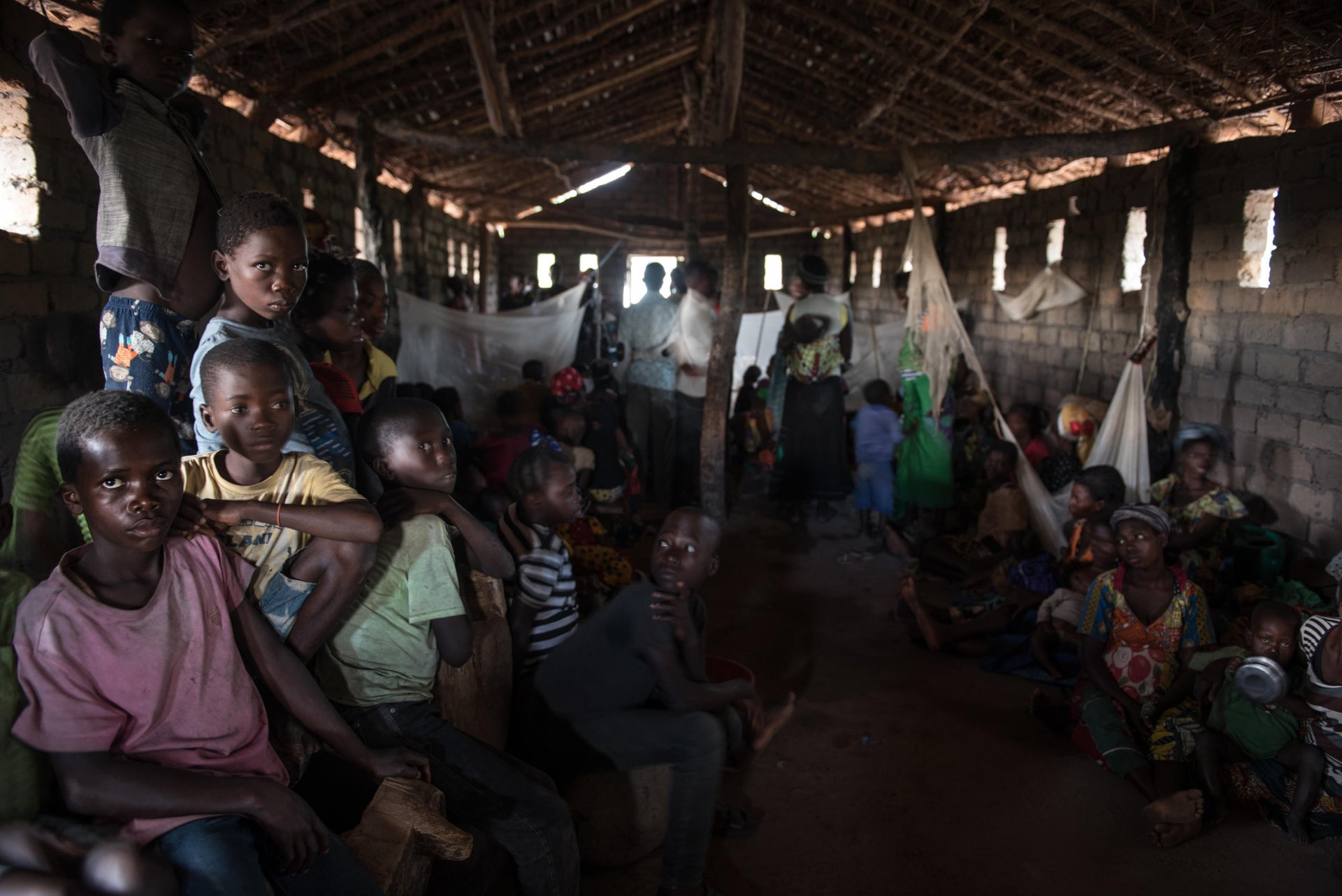 On the outskirts of Nyunzu village in eastern Congo, stands a small thatched roof church. A hundred men, women and children huddle together inside, sheltering from torrential monsoon rains. 

Families live on top of each other in appalling squalor. The raw coughs of children are muffled by the rain spitting through the roof. They sleep rough on wet soil, thinly covered by empty sacks of sugar. 

Four people have died since the group fled to this church for safety in September, including two children. This scene is replicated in countless churches across Congo, as a little known conflict is tearing the central African nation apart.

An upsurge in violence in several parts of DR Congo in 2016, has left over 1.7 million people to flee their homes this year alone; that’s over 5,500 people per day. 

This week the DR Congo was declared the worst affected by displacement in the world by the global analysts, IDMC. Tanganyika province, is one of the hotspots of the current crisis.

Despite the UN putting the world on notice about Congo’s crisis, little has changed since October. Money has only trickled in to help the 13 million people in need. Today the country is the second lowest funded of the world’s largest crises - less than half of the US$812 million aid appeal is funded. 

The violence has prevented many families from accessing land and maintaining their livelihoods. 7.7 million people are severely food insecure, up 30 per cent in a year. Lack of access to clean water has led to a cholera outbreak that has killed some 600 people.

Photos: NRC/Christian Jepsen 
Date: 1 December 2017