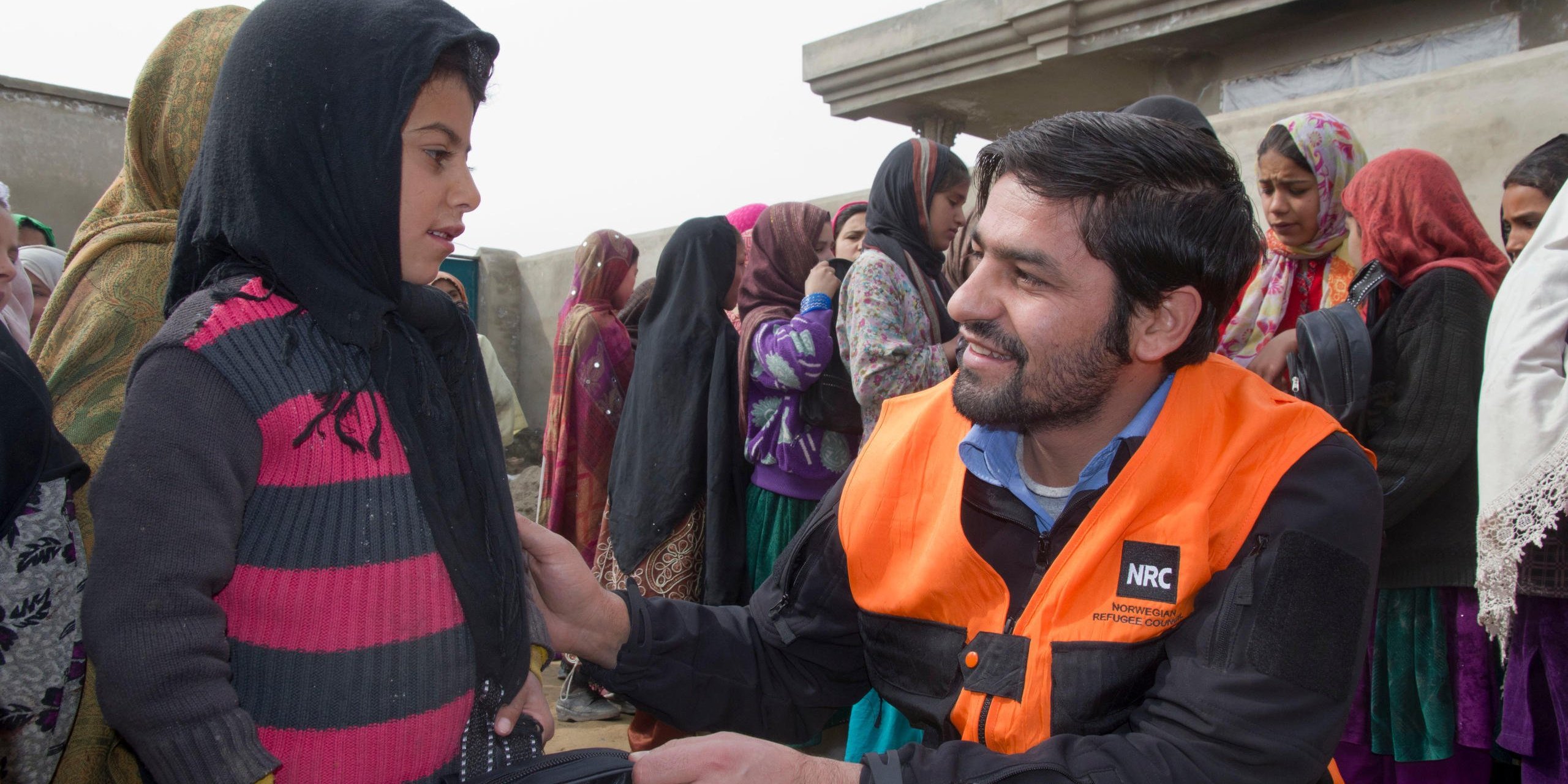 Distibution of school supplies by NRC employee Said Ebad Hashemi. Photo Credit NRC/Ingrid Prestetun