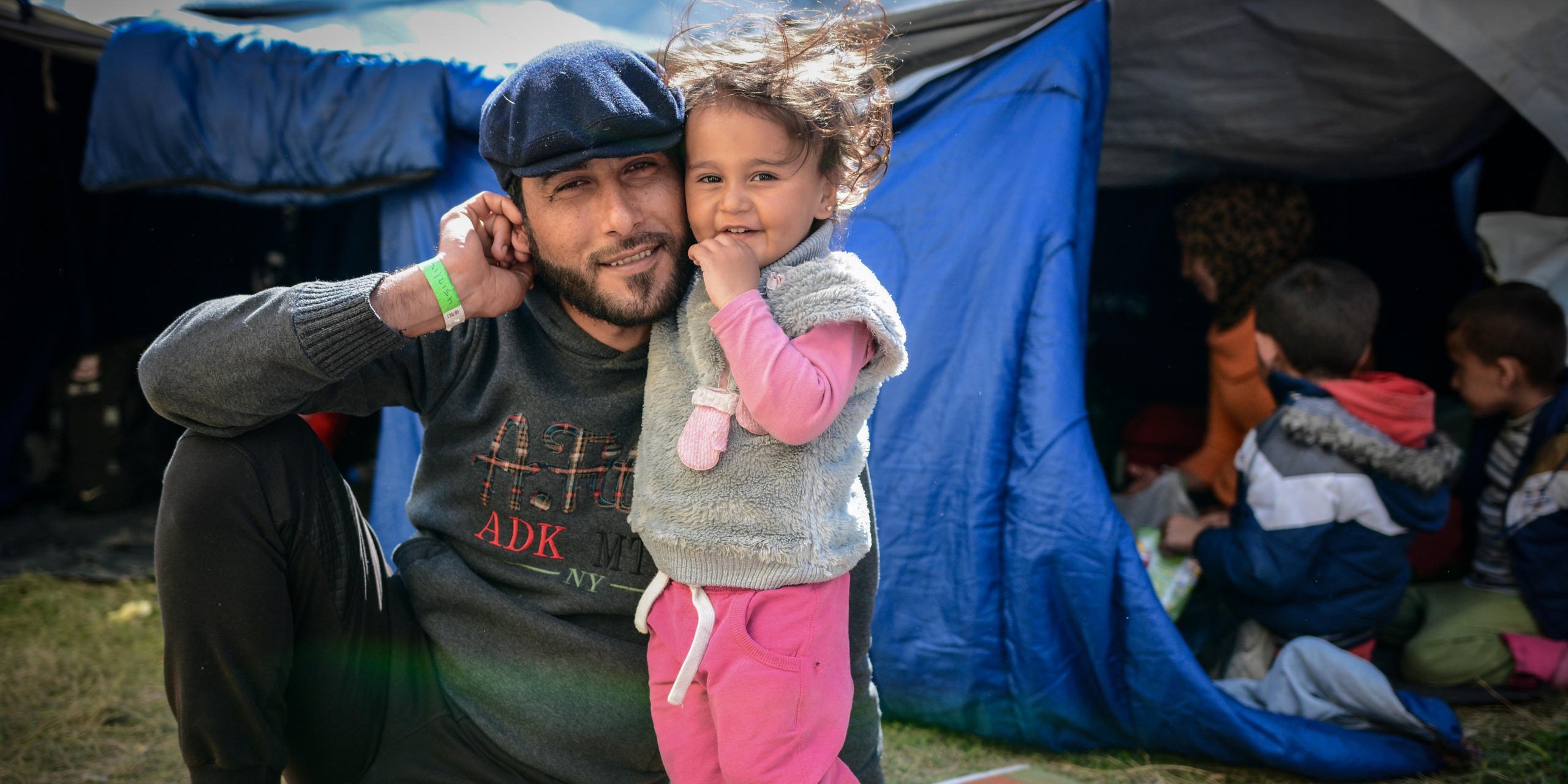 Jamal and Asinat (2) at Depethe camp at Chios, Greece (open facility). Photo: Tiril Skarstein, NRC.

Interview with Jamal - fleeing with his wife and their child Asinat (2).
Planes were bombing our neighbourhood. One bomb hit our home and I had an injury in the stomach and I was taken to hospital were I had an operation. My wife was also hit in her shoulder. But luckily is was able to shield Asinat (2). It was during the previous Ramadan. We decided we need to get to safety in Europe. The travel has been very difficult, both to cross from Syria to Turkey and across the sea to get to Greece. We have been close to death. 

We escaped form the war, but here in Greece we were taken to a detention center. We have no rights here. We escaped the war, but for what? I have friend in Oslo and other parts of Europe and they tell me that their rights are respected - but here we have no rights and there´s no humanity.
I am afraid we will be sent back to Turkey. There is no life for us there. 
In Syria we would die quickly, here we are dying slowly. In Syria we would be killed in the war, here the despair is strangling us. 

See also video interview.