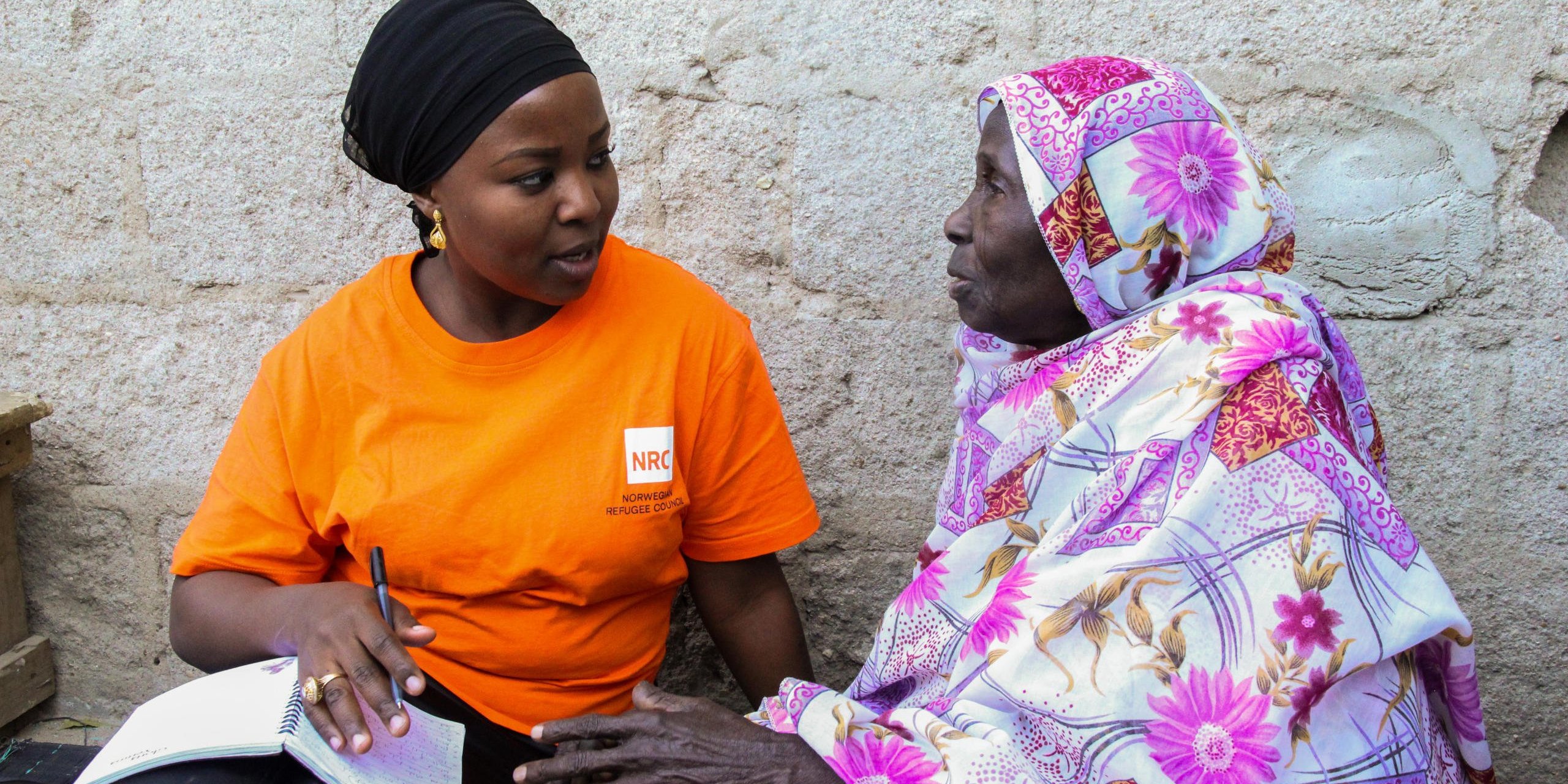 Munakur having an interview with karu(old woman on the right) who is an IDP living in Bulabulin. She is also a beneficiary of NRC’S red rose NFI/food voucher card. 

Photo: NRC/Ingrid Prestetun
