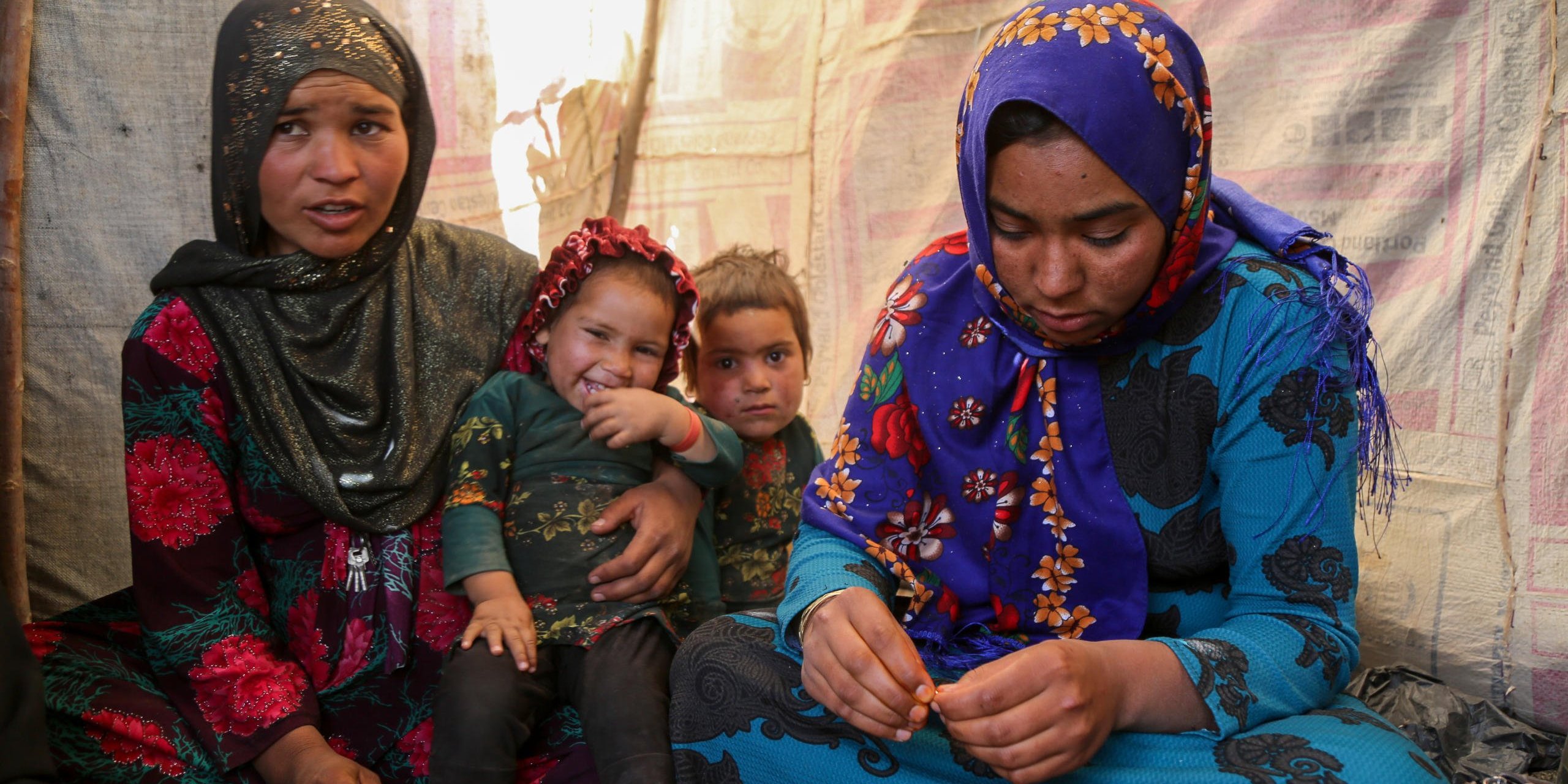 Sultana, 24, (right in blue) and Hajira, 32, (left in dotted red)
Sultana lost her three months daughter due to cold in one of the IDP settlement in Badghis, Afghanistan. The family have forced to come from Kharistan area to Qala-e-naw city due to sever drought some two months ago.
"My little was fine before we left the village. We came here and slept in the open with only a tarpaulin over our head. My daughter got pneumonia at the beginning and latter she died," said her mother grieving.
"She cries all the day and often comes here to talk to me and forget about her daughter," Hajira mother of five said.
"She lost her daughter due to cold and it made me worried not losing my children," she adds.
Hajira has five children and also a seven months pregnant. She asks for immediate shelter and winterization assistance as winter is looming.
"We can't go back to our home because we can't find even a drop water as all wells and water sources have dried up," she said when we asked if they are planning to go back. Though the family do not have proper shelter in Sanjetak settlement, but they have been provided with water tracking and water tanks.
PHoto: NRC/Enayatullah Azad