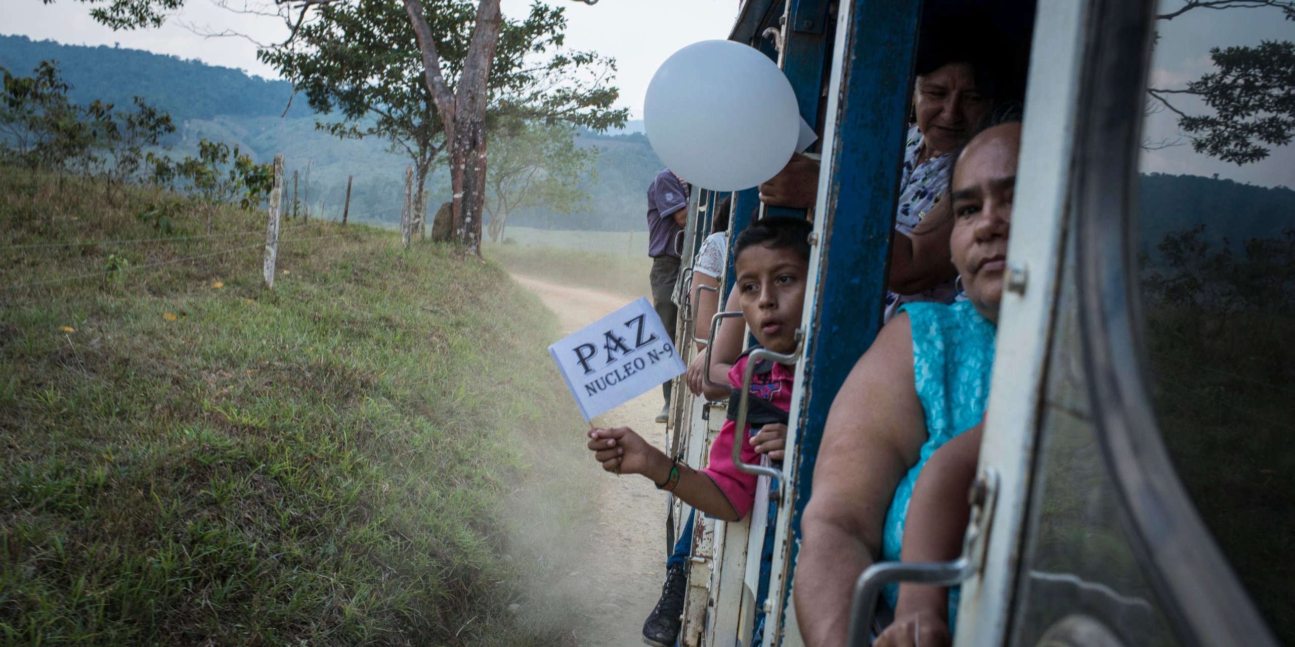 February 6, 2016. North Caquetá department. A child waves a white flag with the writing “Peace” on it. With his family, he comes back from a “peace pedagogical” meeting at El Para village where peasant organizations presented and explained the peace talks between the FARC guerrilla and the Colombian government at Cuba.
After four years of negotiations and a first peace deal signed at end of September 2016, Colombia entered into an unexpected period when 50,22% of the referendum voters rejected the agreement on October 2. Some days after, the president Juan Manuel Santos received the Nobel peace prize. The negotiators began a new round to adapt the agreement with some “No” positions and a new peace was approved by the congress on November 24.
Photo credit: Nadège Mazars