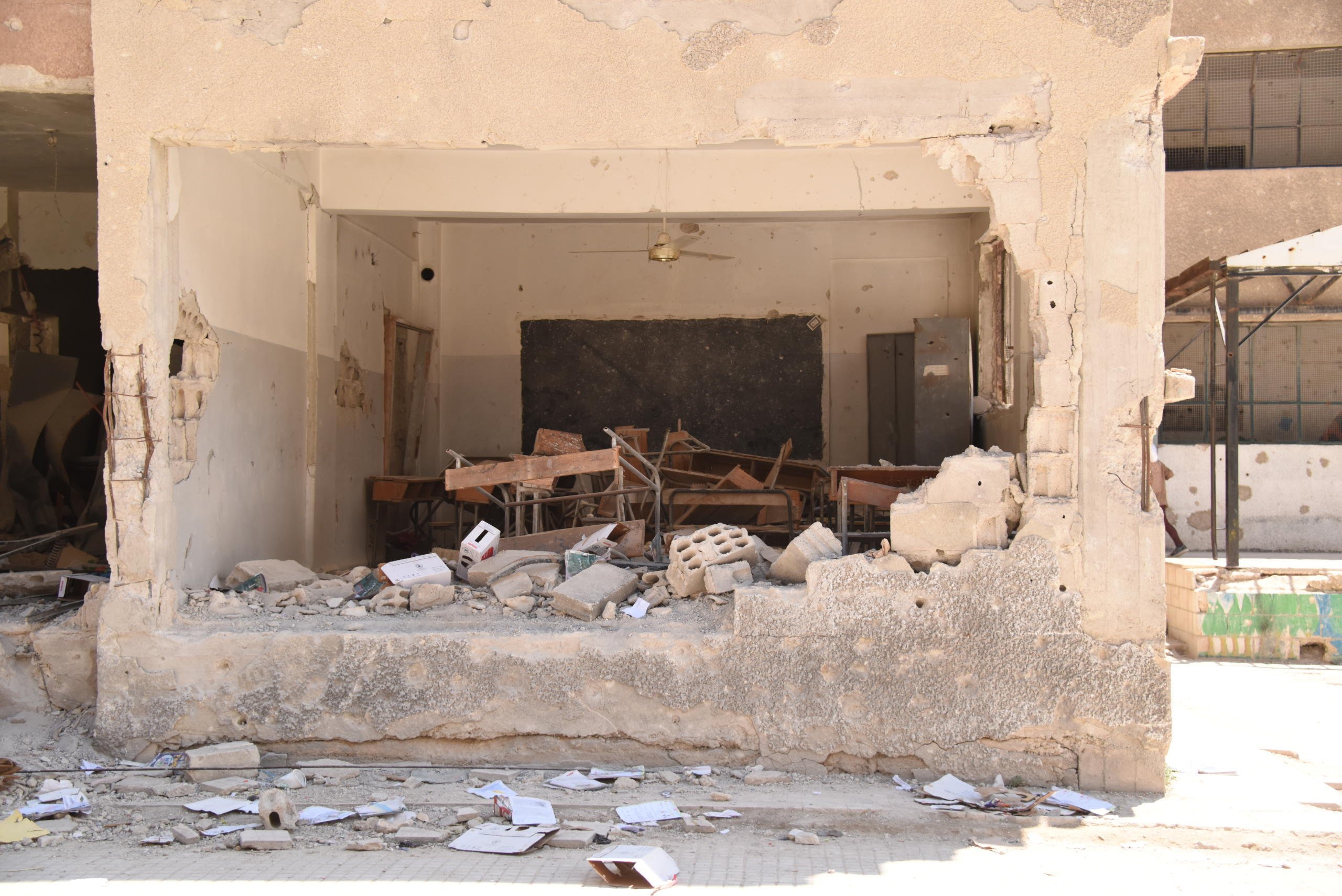 This school in Harasta, Eastern Ghouta, has been half destroyed, with other parts heavily damaged. NRC’s shelter team estimates that at least US$500,000 are needed to repair and rebuild the school. Nevertheless, students and teachers are making use of the few remaining classrooms to catch up on years of lost education. There are currently 725 children attending this school. 
Photo: Karl Schembri/NRC
