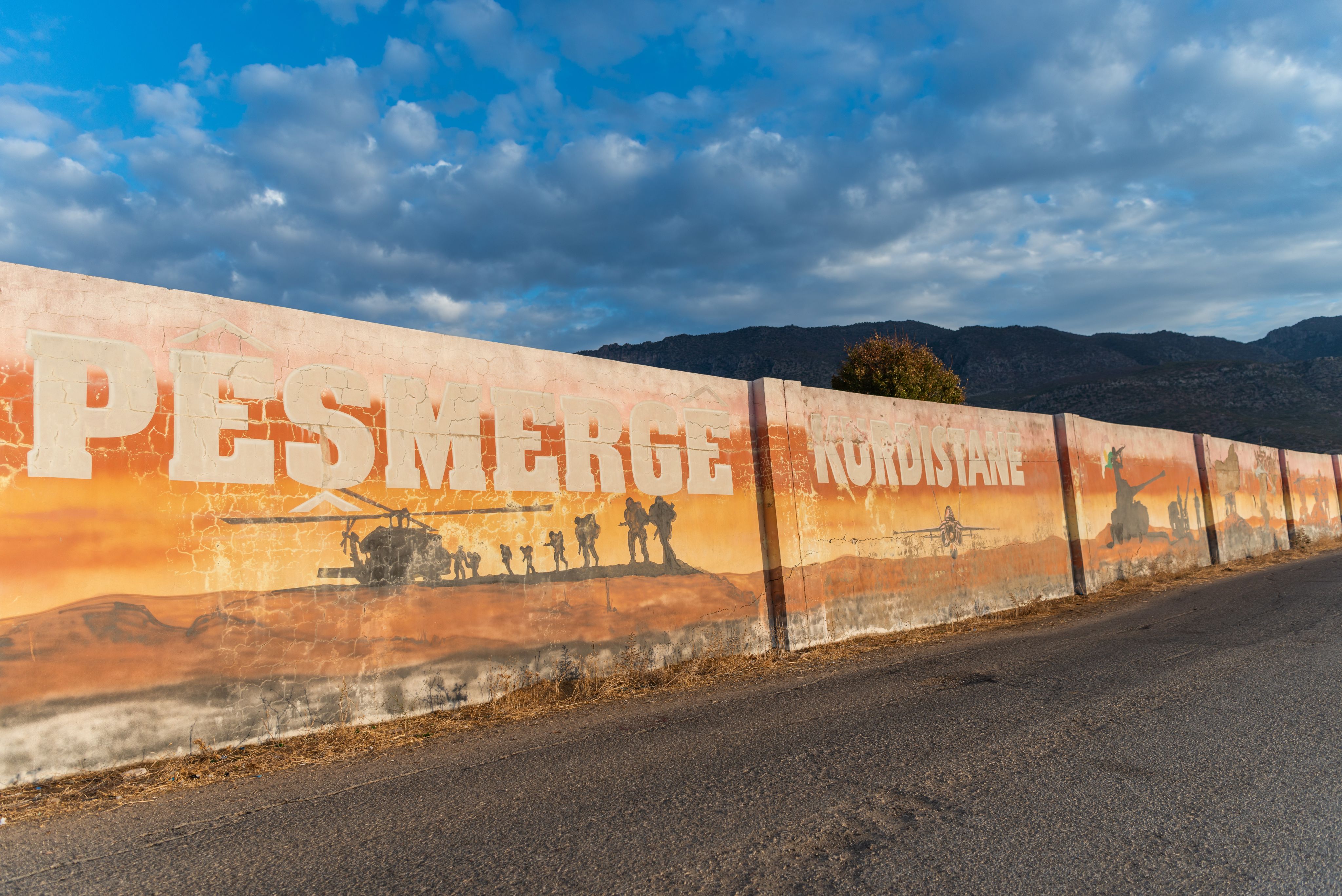 A wall with paintings of Peshmerga forces.