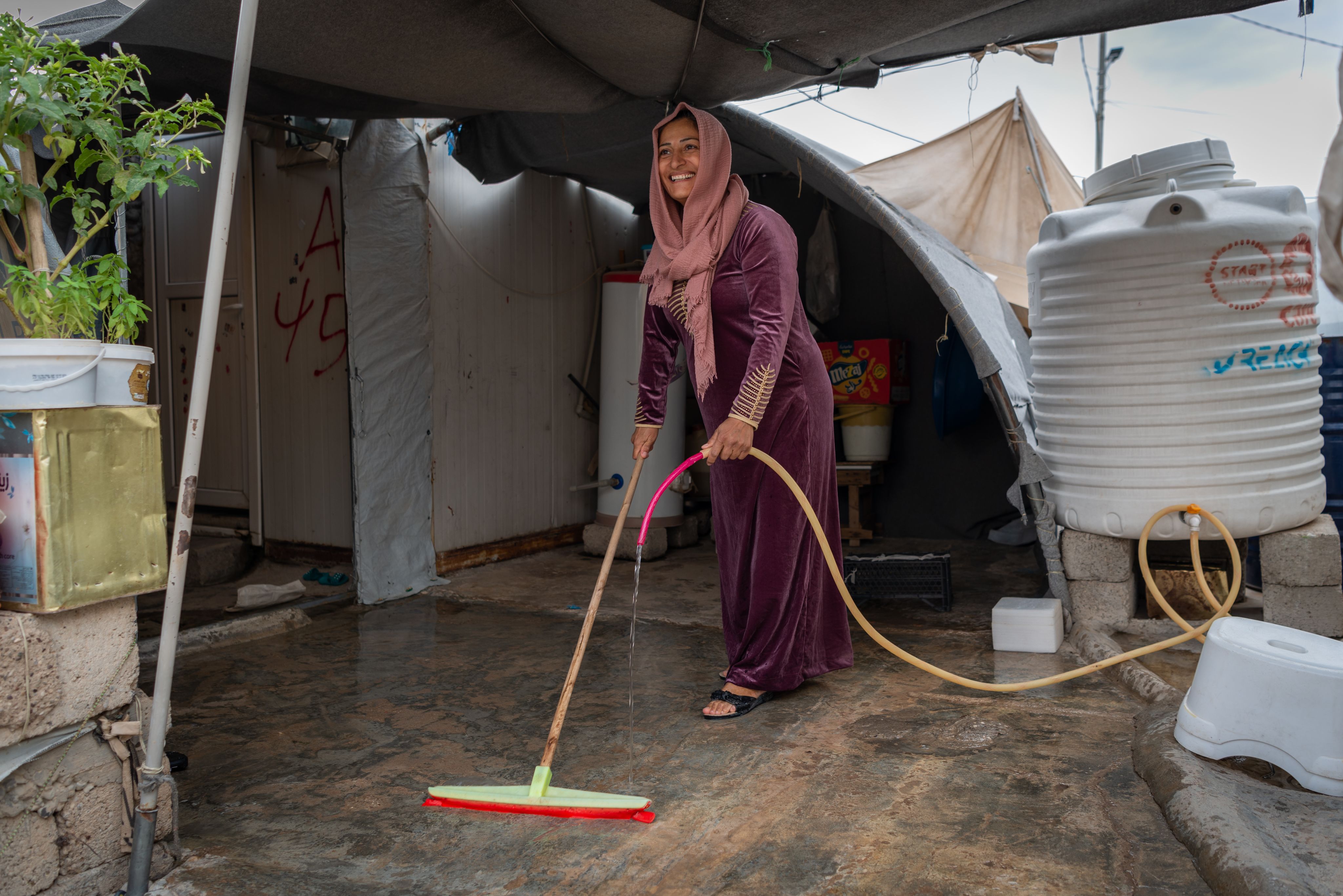 A woman cleaning the floor of her home.