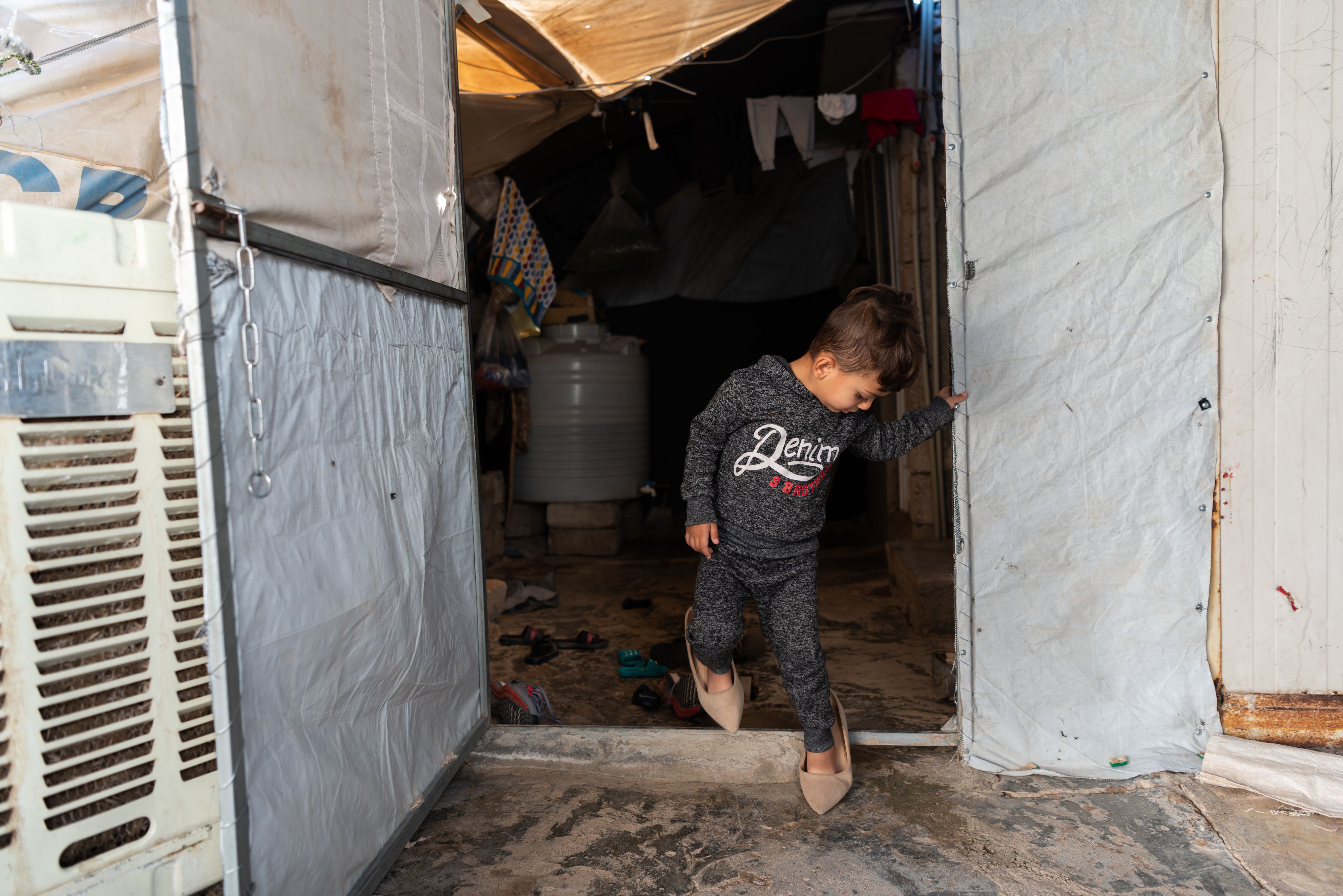 Boy in his mother's shoes.