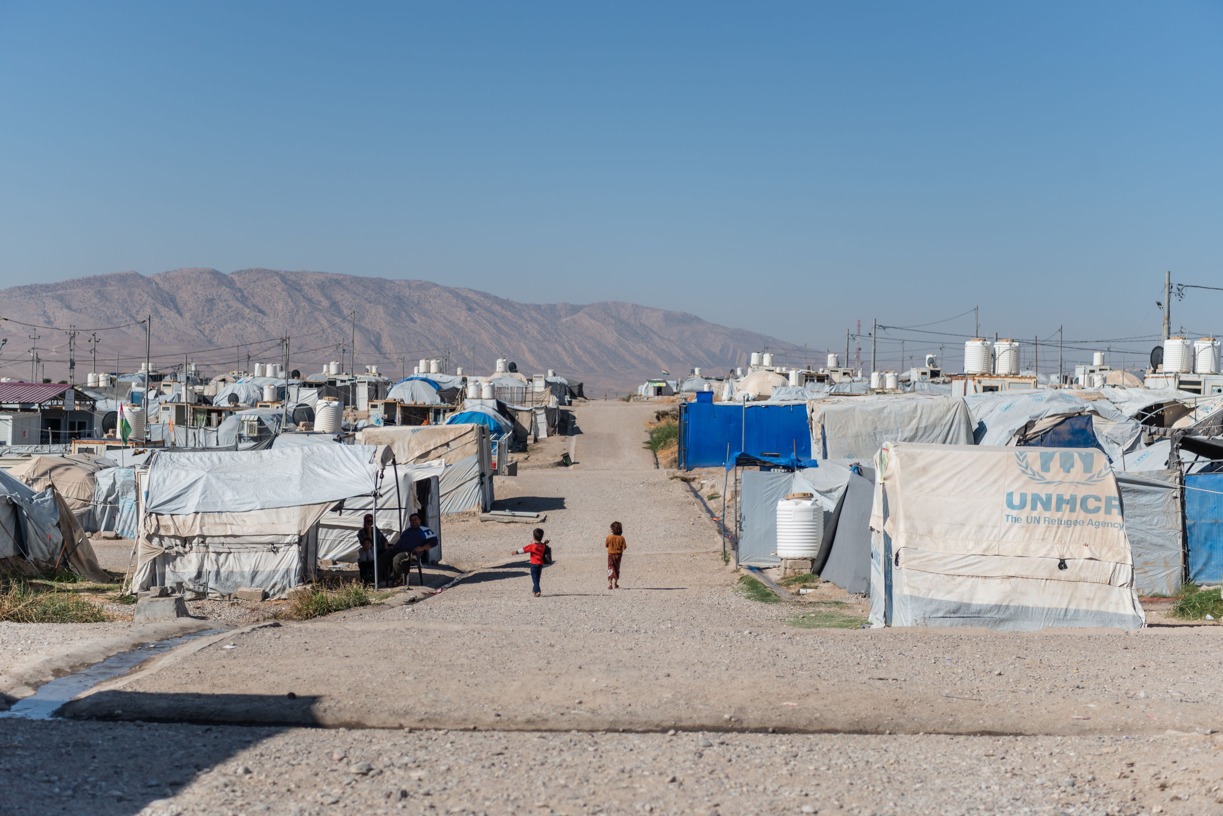 A refugee camp in a dry, mountainous setting.