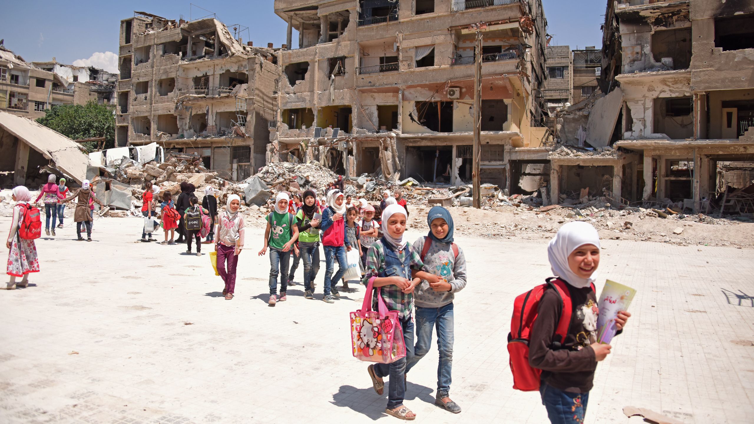 Children living in Harasta, Eastern Ghouta, flock to school to catch up on years of missed education.